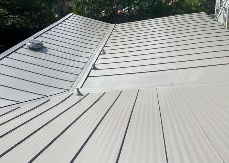 Solar attic fan installed on a metal roof for Roof Ventilation in Overland Park
